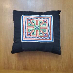 Decorative needlepoint throw pillow.